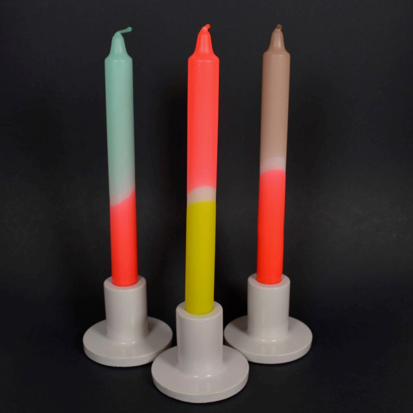 Multicoloured candles in holders