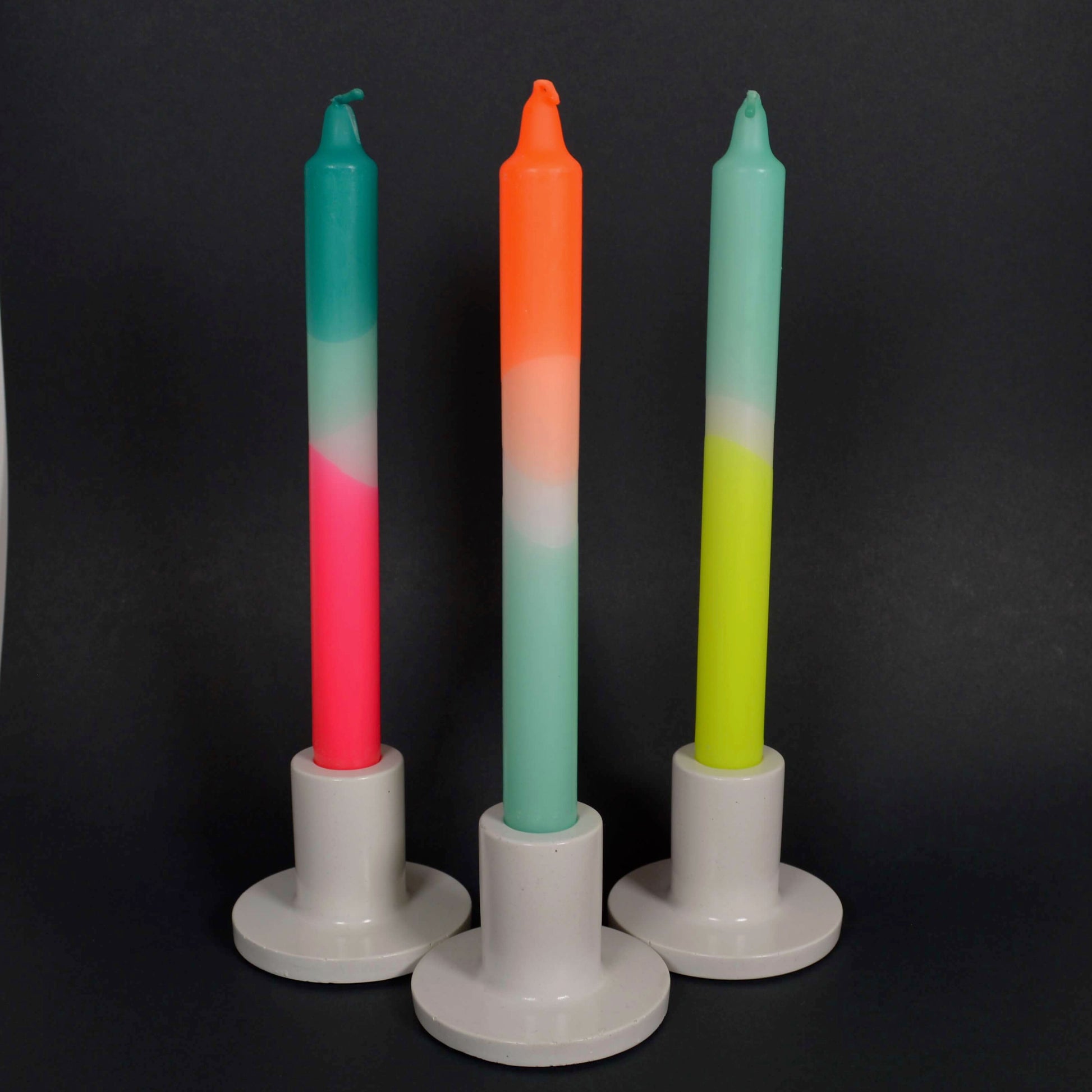 3 Neon Candle Sticks placed in Holders